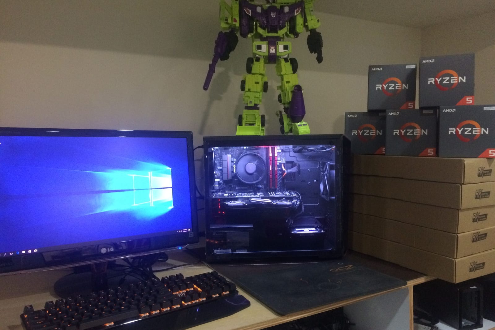 The 2017 bench: a Ryzen 5 build beside a stack of boxed Ryzen 5 processors