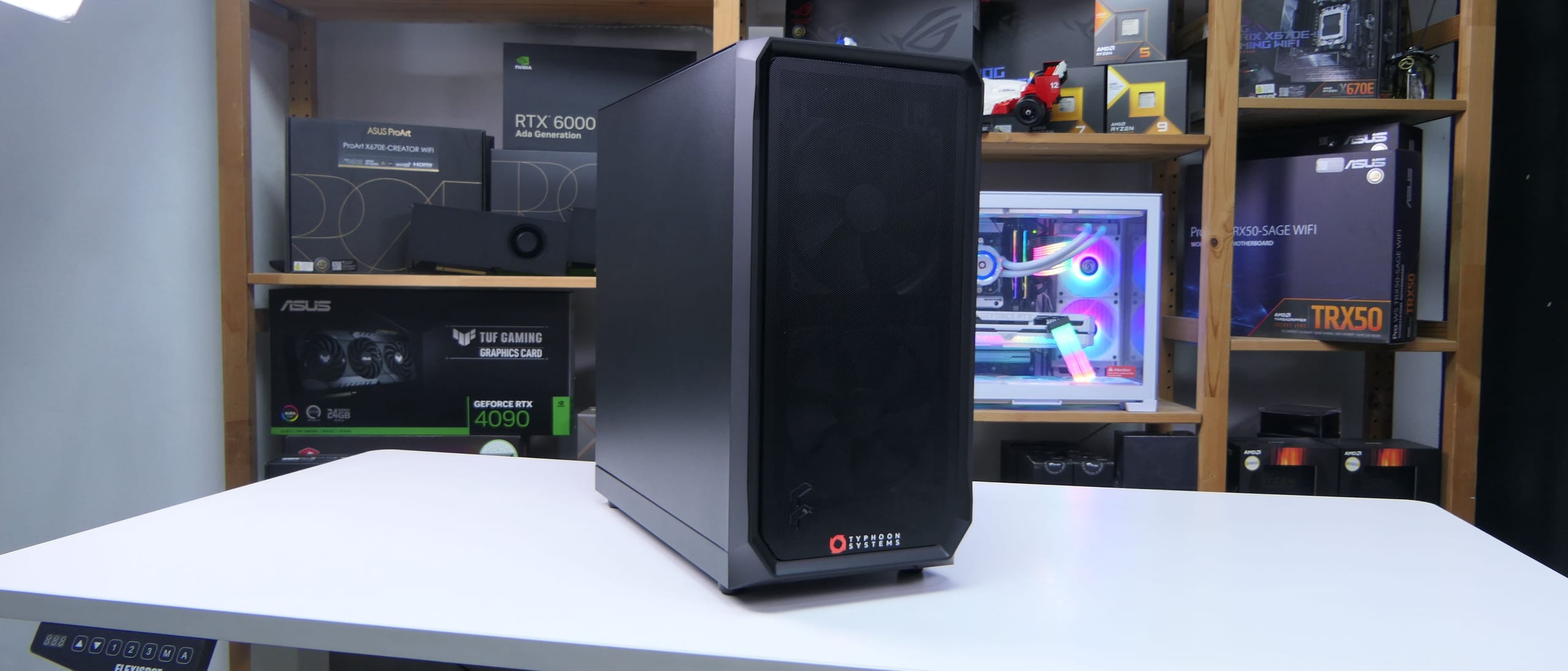 A finished build on the white bench at Kallang, shelves of boxed parts behind it